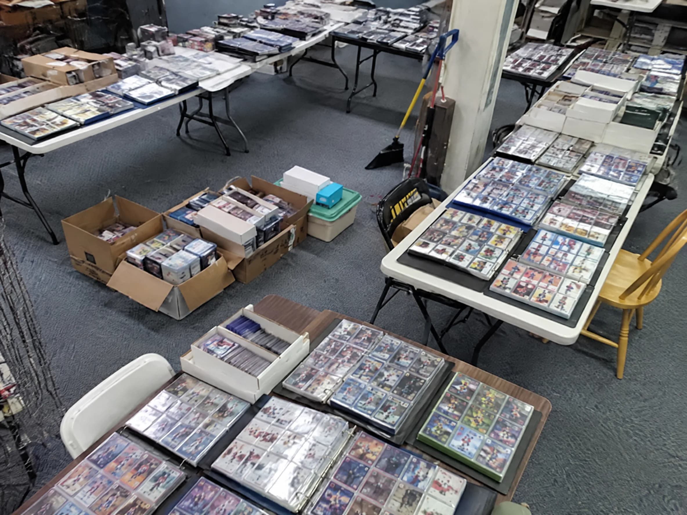 Shelves of card binders, one open and being flipped through.