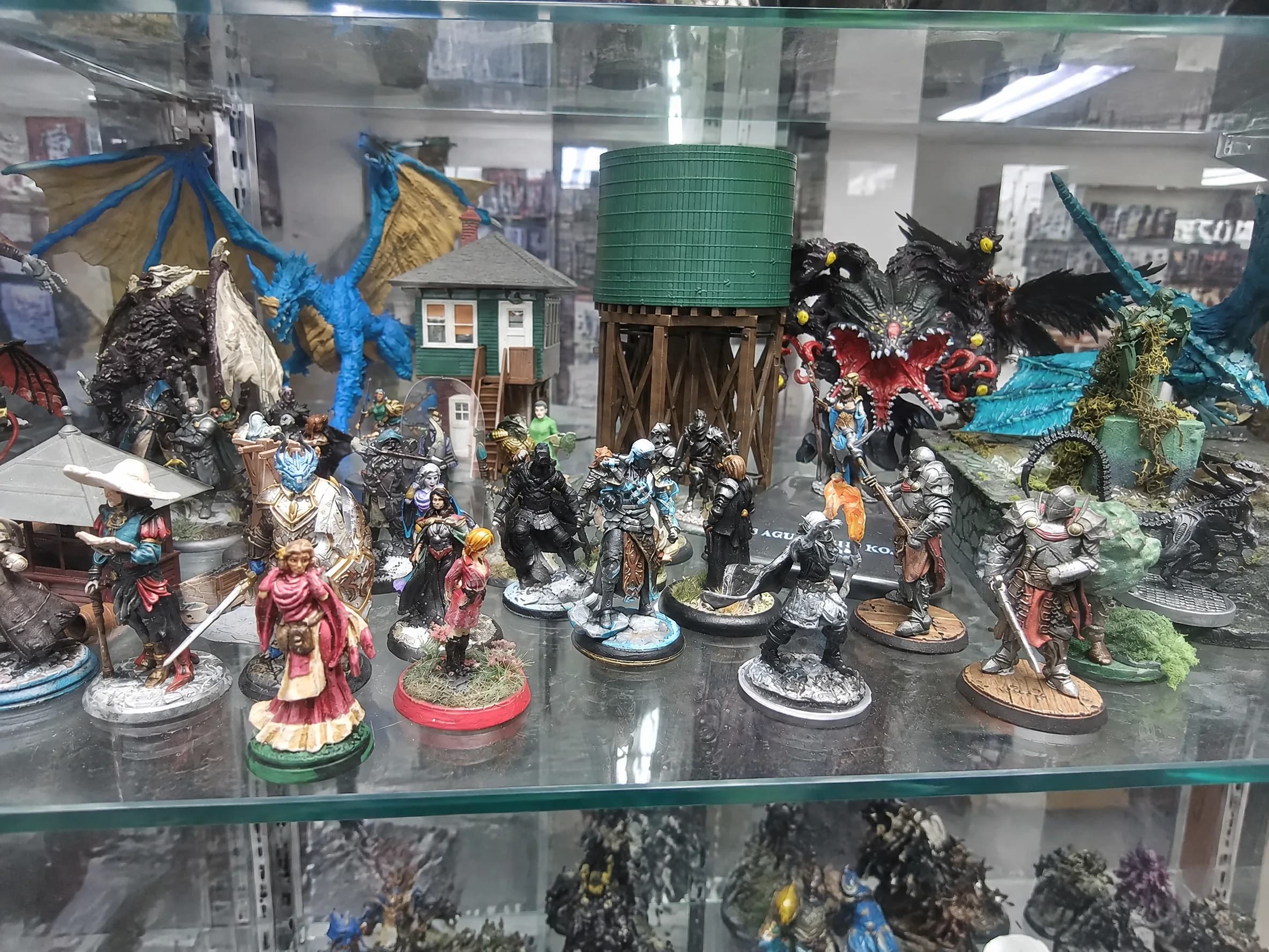 Painted miniatures and dioramas in a display case.