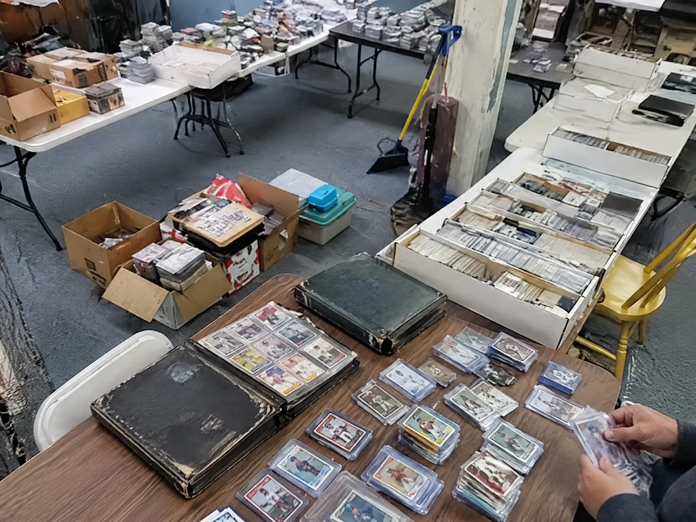 Binders and a box of cards on the counter, being looked over.